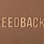 Wooden FEEDBACK sign on a textured background, representing how to automate customer feedback analysis with AI