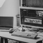 Laptop and monitor set up for video editing, representing AI subtitle generators for video content