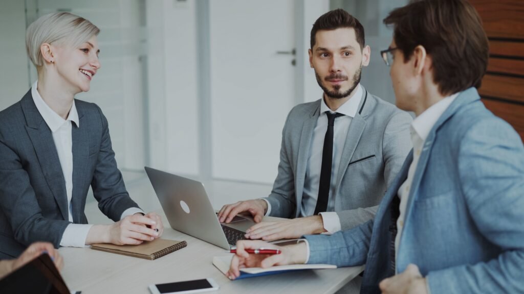 Business professionals discussing sales strategy in a meeting, representing how to automate lead generation with AI
