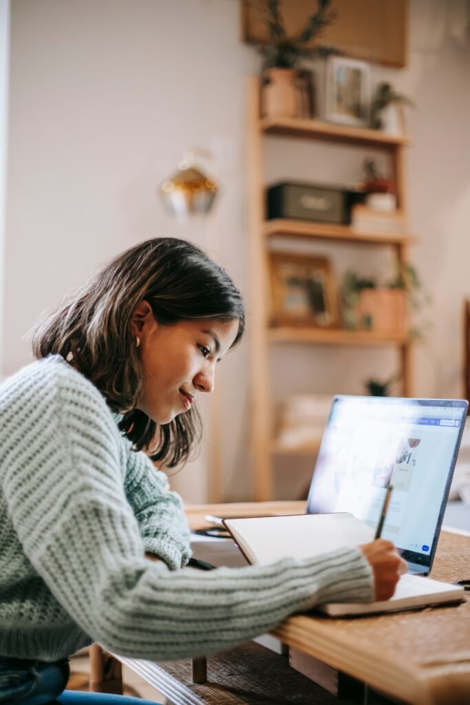 Student taking notes on a laptop while studying, representing AI note taking apps for students