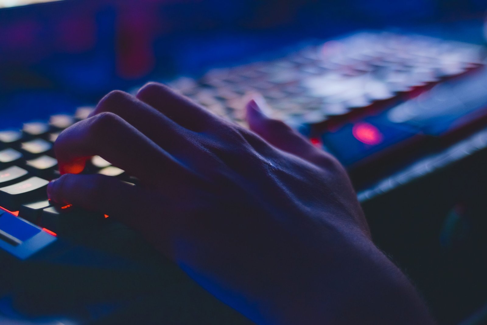 Close-up of hands typing on a laptop keyboard, representing keyboard shortcuts and browser tricks for AI tool workflows